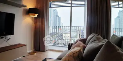 Spacious bedroom with large windows and balcony access