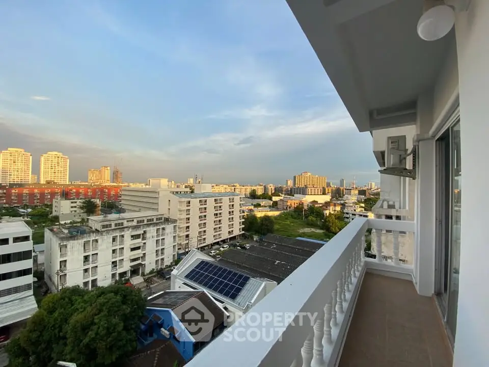 Stunning cityscape view from a spacious balcony at sunset, perfect for urban living.