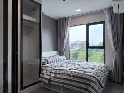 Modern bedroom with large window and stylish decor in urban apartment