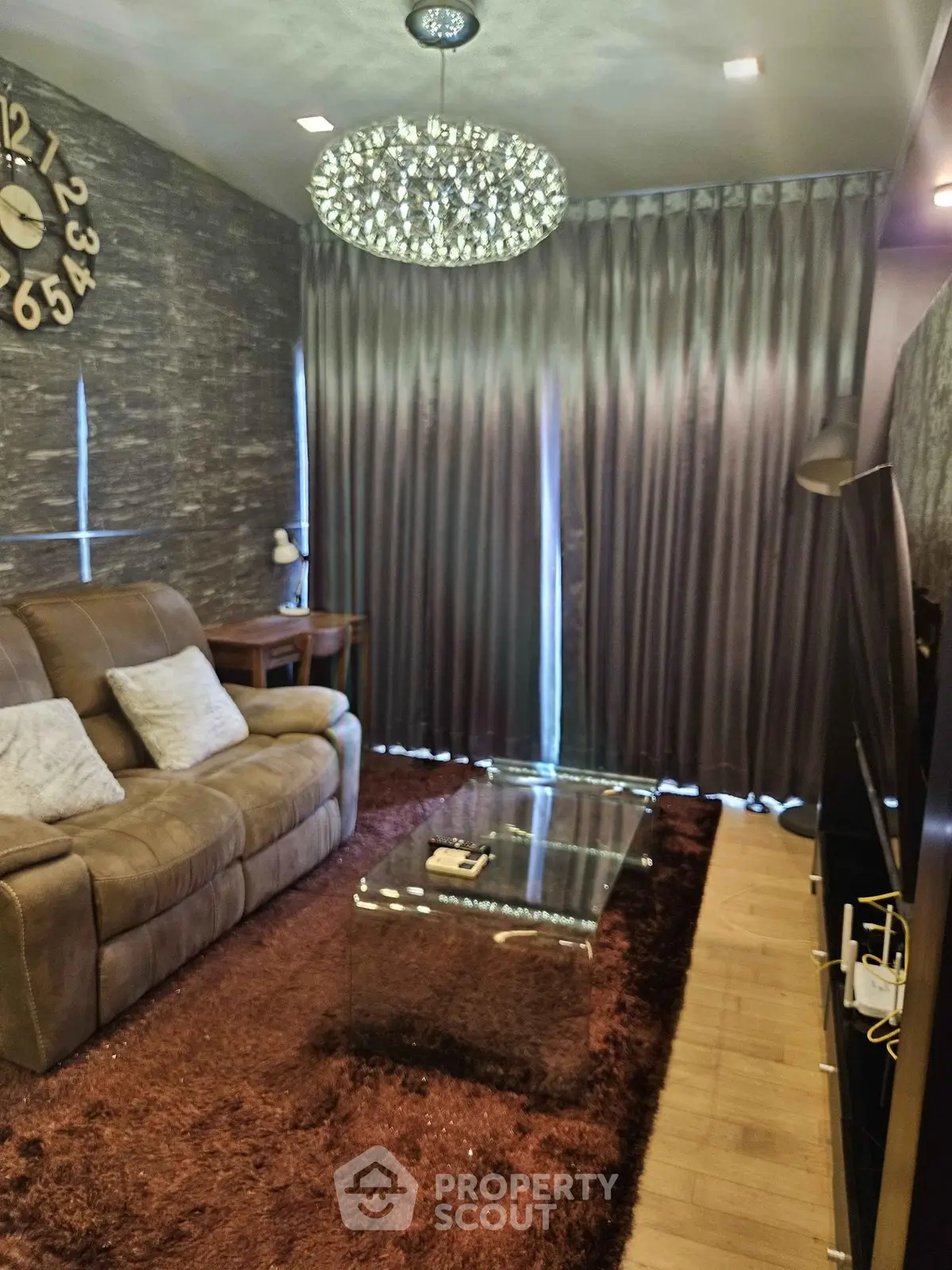 Luxurious living room with plush seating, elegant chandelier, and modern decor for a cozy ambiance.
