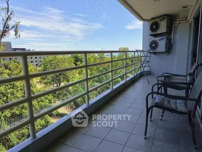 Spacious balcony with scenic view and outdoor seating in modern apartment