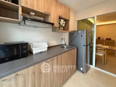Modern kitchen with wooden cabinets and stainless steel appliances