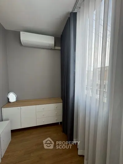 Modern bedroom with air conditioning and elegant curtains