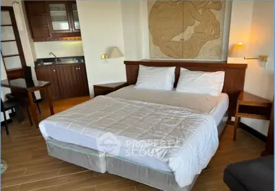 Cozy bedroom with kitchenette and modern decor, perfect for urban living.