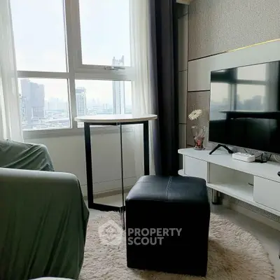 Modern living room with city view, stylish furniture, and sleek TV setup.