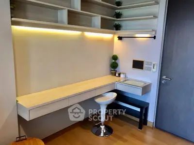 Modern study area with sleek desk and stylish stool in a contemporary home.