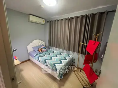Cozy bedroom with single bed, air conditioning, and stylish decor