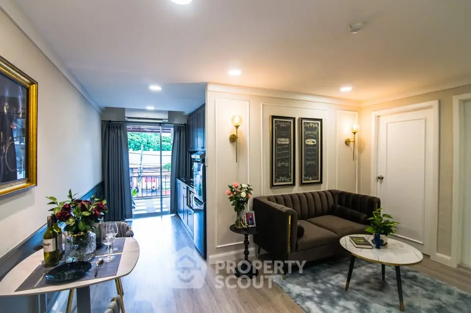 Stylish living room with elegant decor and open layout leading to a balcony, perfect for modern living.