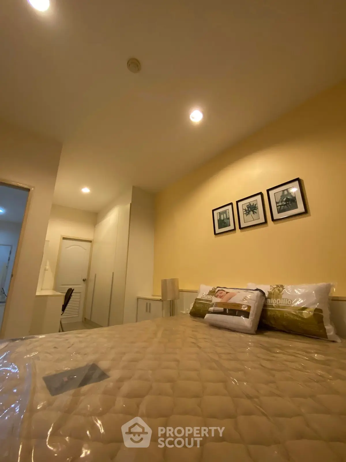 Cozy bedroom with modern decor and soft lighting, perfect for relaxation.