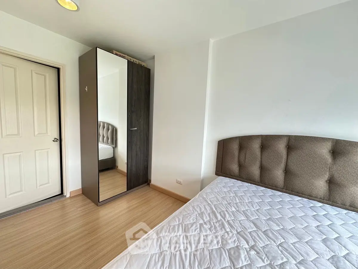 Cozy bedroom with modern wardrobe and comfortable bed in a bright apartment