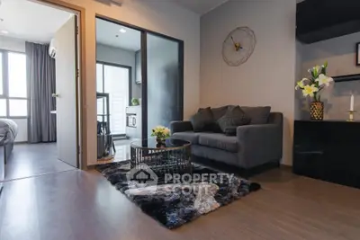 Modern living room with stylish decor and cozy seating in a contemporary apartment.