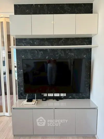 Modern living room with sleek TV unit and marble accent wall