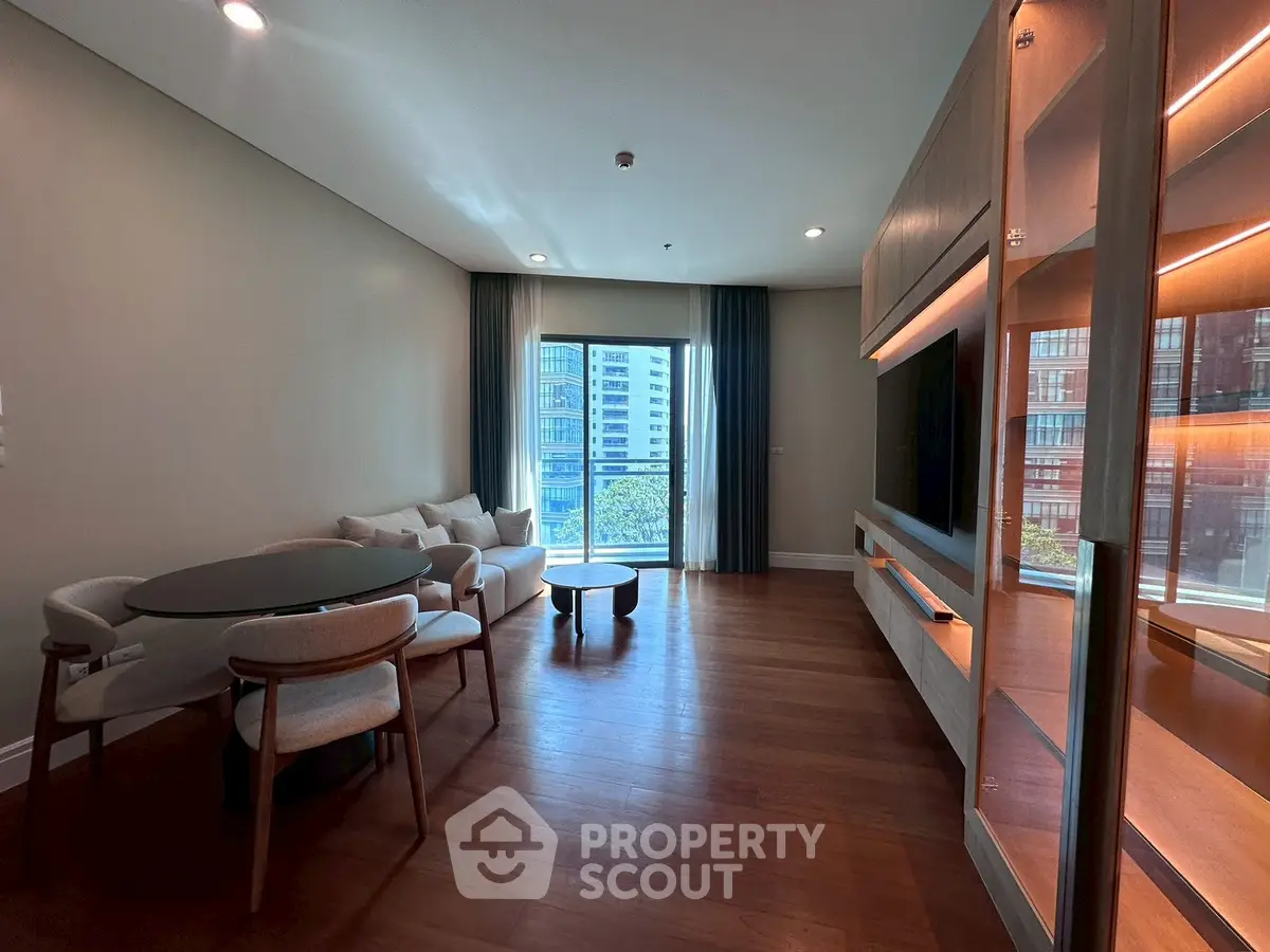 Spacious modern living room with elegant furniture and city view.