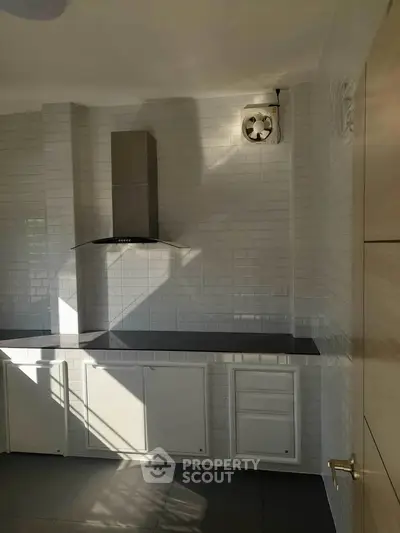 Modern kitchen with sleek white cabinets and stylish range hood