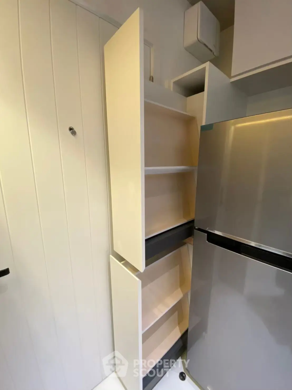 Modern kitchen with sleek fridge and pull-out pantry storage