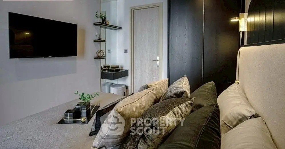 Stylish modern living room with plush cushions and wall-mounted TV