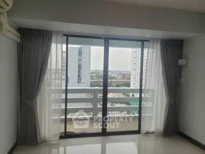 Spacious apartment with large windows offering stunning city views and abundant natural light.
