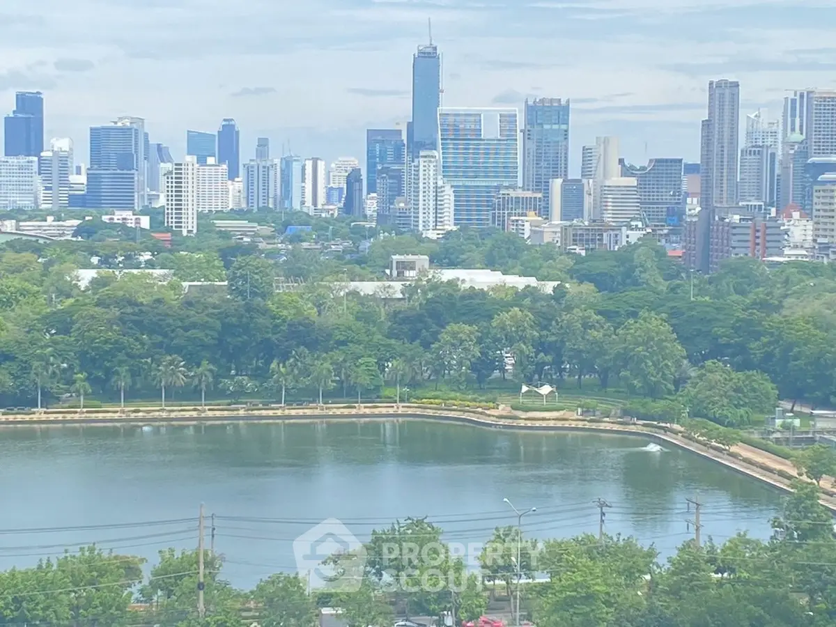 Stunning cityscape view with lush greenery and serene water body, perfect for urban living enthusiasts.
