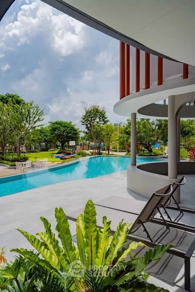 Luxurious poolside view with modern architecture and lush greenery