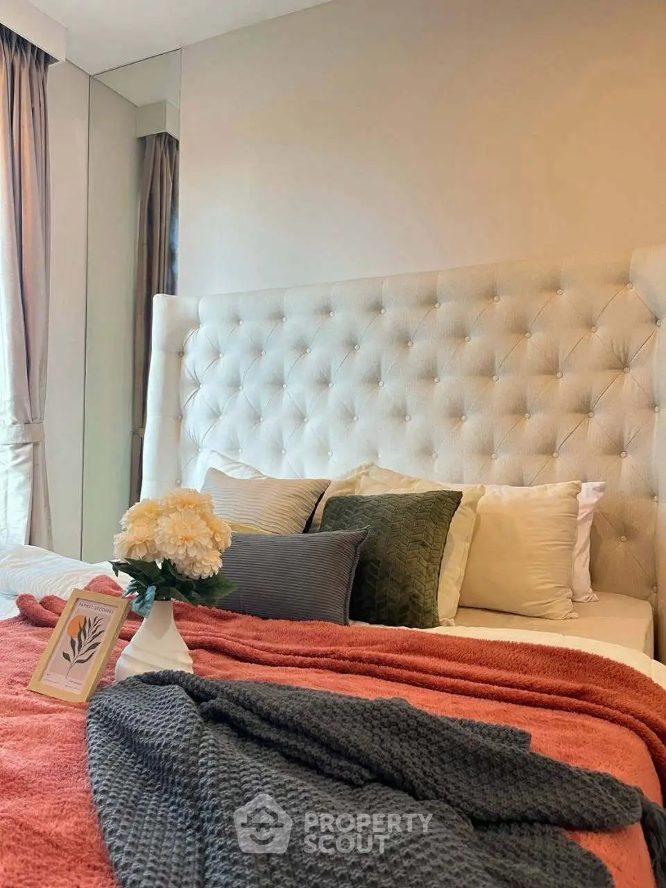Luxurious bedroom with plush headboard and elegant decor