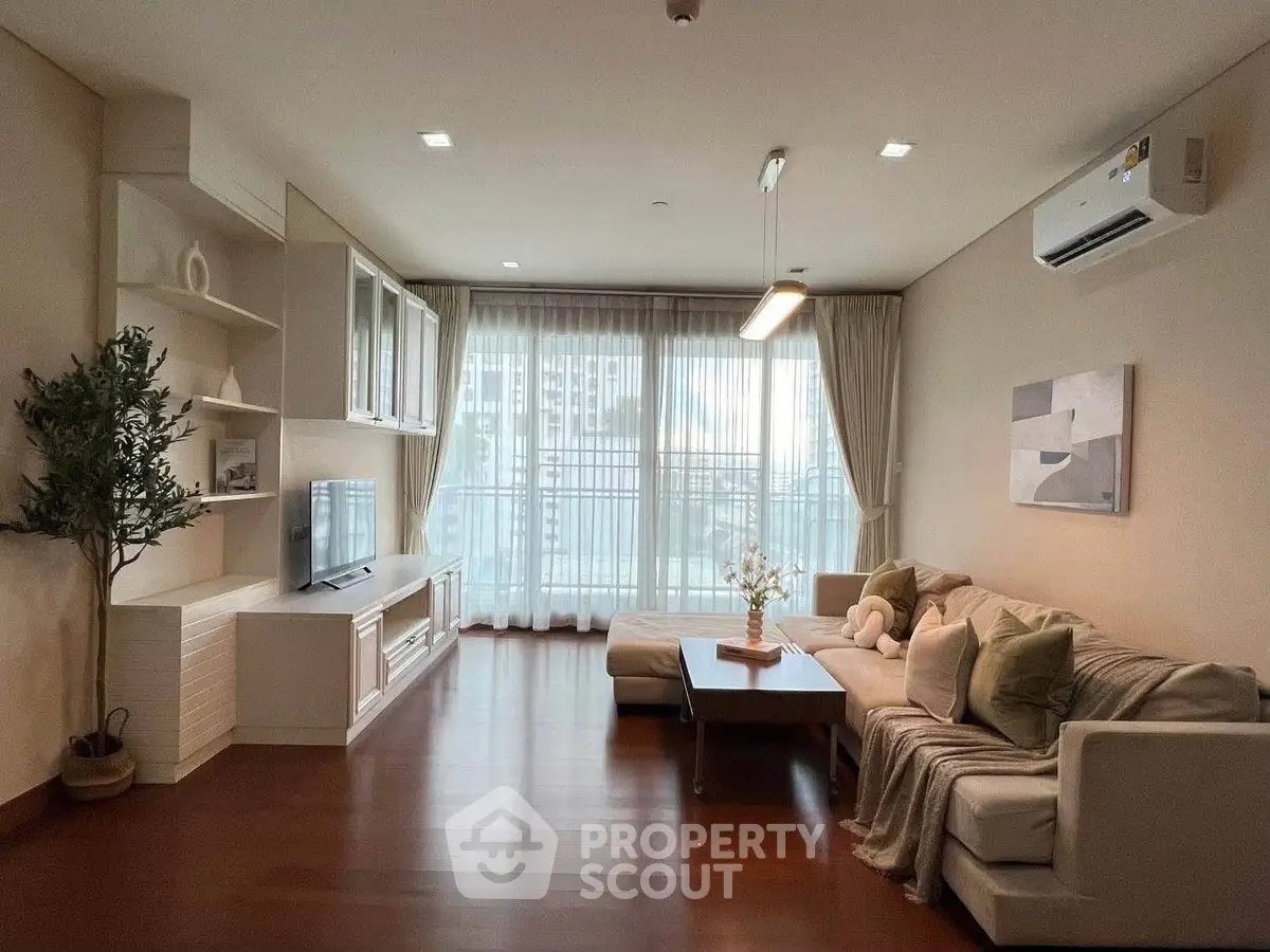 Spacious modern living room with large windows and elegant decor