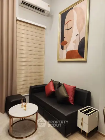 Stylish living room with modern art, sleek black sofa, and elegant decor