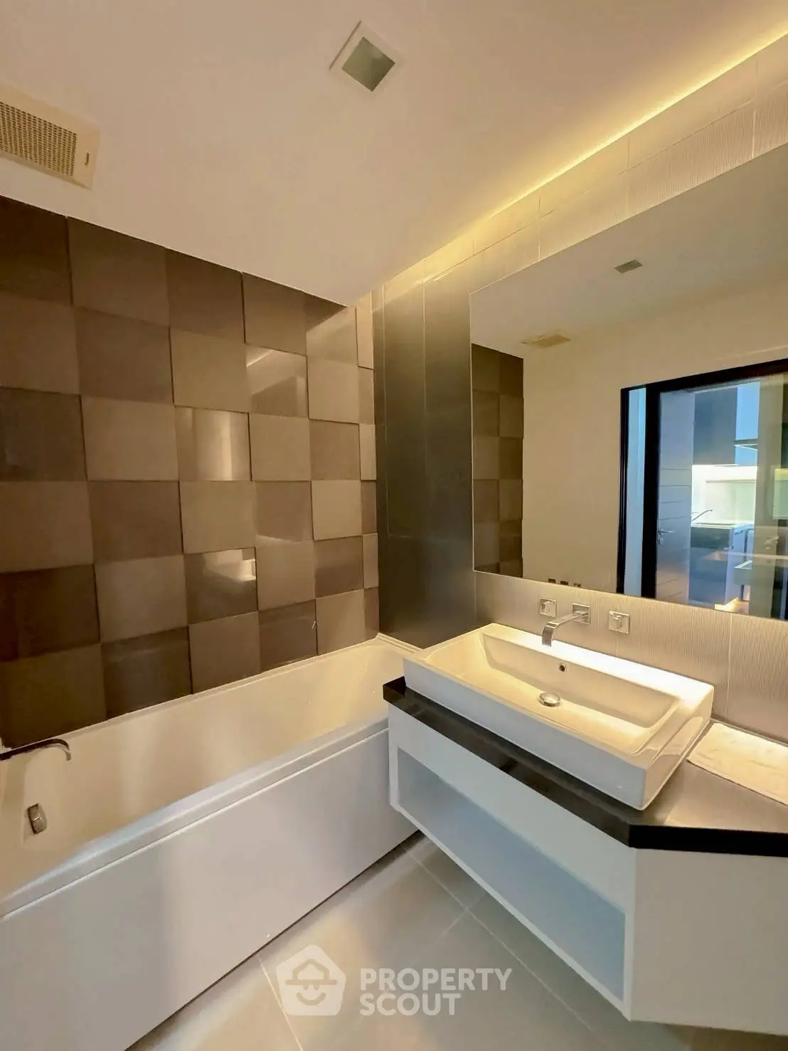 Modern bathroom with sleek design, featuring a bathtub and stylish vanity in a contemporary home.