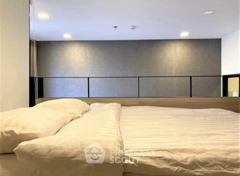 Modern bedroom with cozy bedding and minimalist design, perfect for relaxation and comfort.