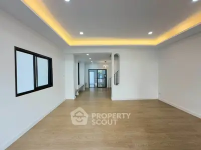 Spacious modern living room with wooden flooring and recessed lighting