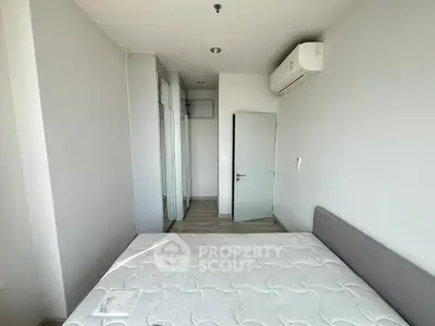 Modern minimalist bedroom with air conditioning and mirrored wardrobe