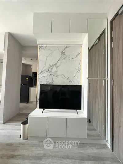 Modern living room with marble accent wall and sleek TV setup