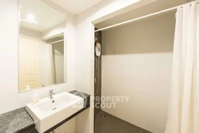 Modern bathroom with sleek sink and spacious shower area