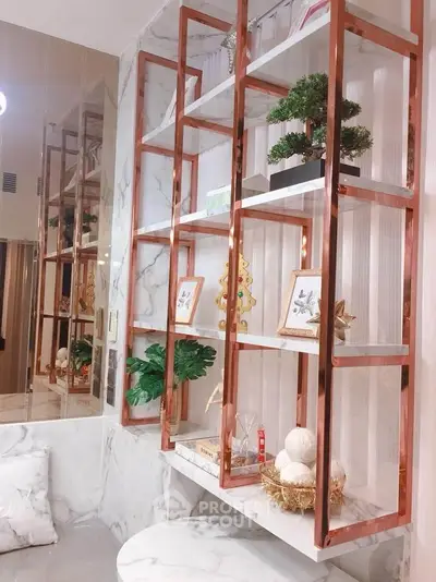 Luxurious marble bathroom with elegant copper shelving and stylish decor accents.