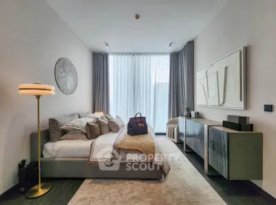 Luxurious modern bedroom with stylish decor and large window for natural light.