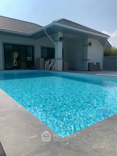 Luxurious modern home with sparkling private pool and sleek exterior design.