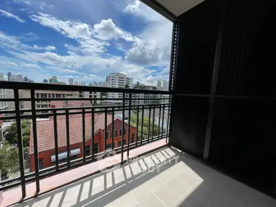 Spacious balcony with stunning city view and modern railing design.