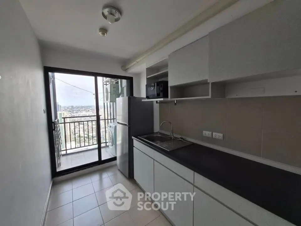 Modern kitchen with balcony view in high-rise apartment