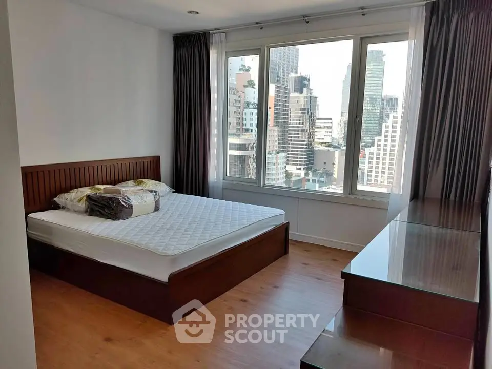 Spacious bedroom with city view in modern apartment