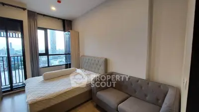 Modern bedroom with city view and cozy sofa in high-rise apartment