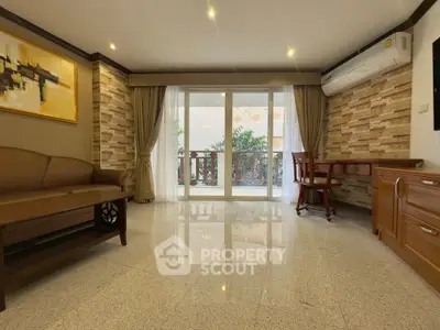 Spacious living room with elegant decor and balcony view