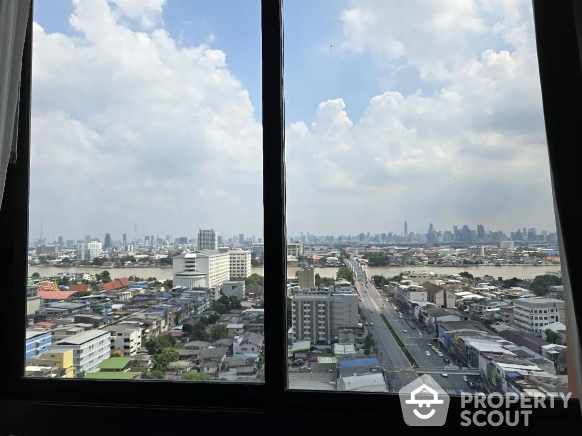 Stunning cityscape view from high-rise window showcasing urban skyline and expansive horizon.