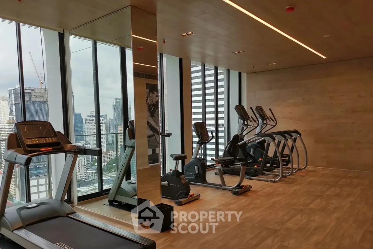 Modern gym with city view in luxury high-rise building