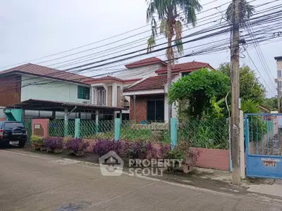 Charming suburban house with lush garden and secure fencing in a peaceful neighborhood.