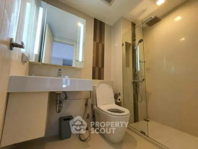Modern bathroom with sleek fixtures and glass shower enclosure