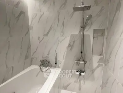 Modern bathroom with elegant marble tiles and sleek shower design