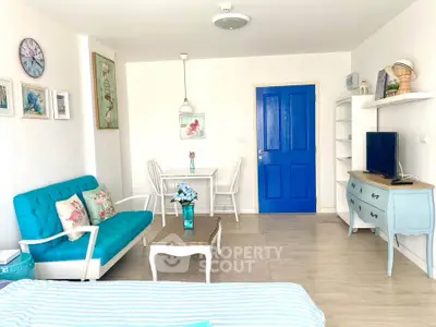 Charming living room with vibrant blue accents and cozy seating area