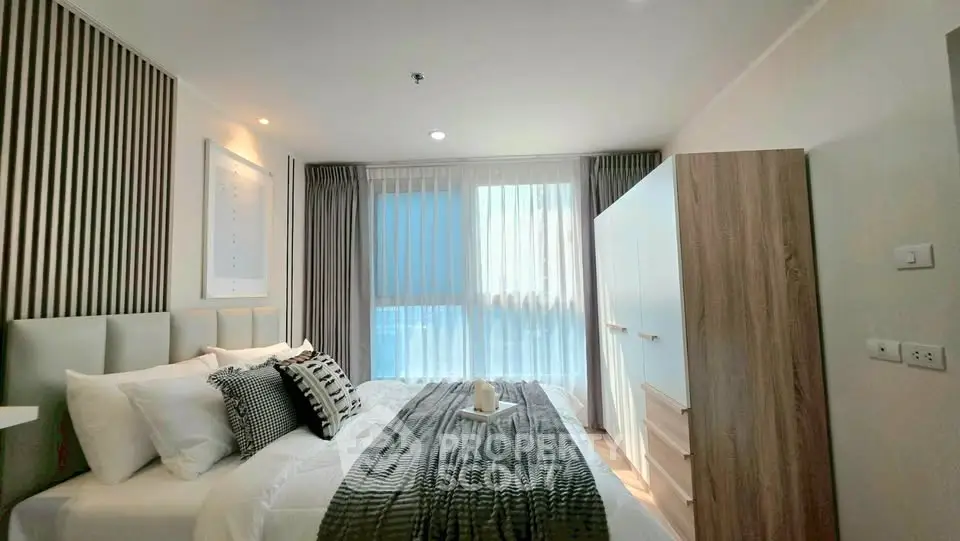 Modern bedroom with stylish decor and ample natural light