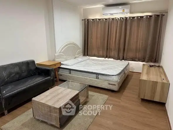 Spacious bedroom with modern furnishings and air conditioning in a stylish apartment.