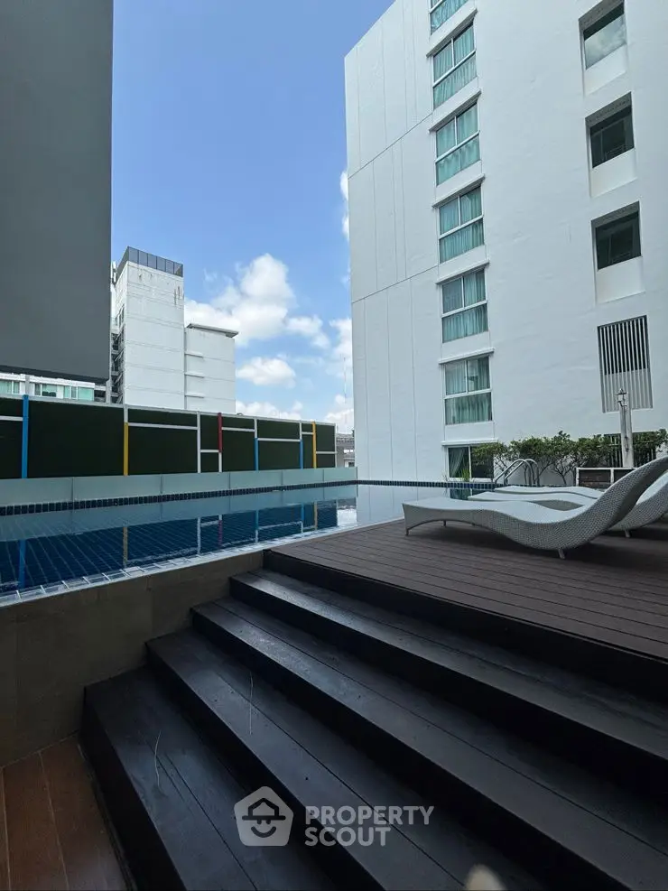 Modern apartment pool area with sleek design and city view