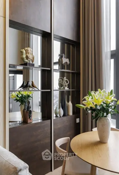 Elegant living room with modern decor and large windows